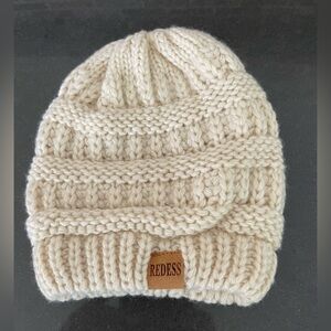 REDESS INFANT/TODDLER KNIT CAP. Cream color. ~5” opening BEFORE STRETCH. 7” Tall
